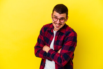 Fototapeta premium Young caucasian cool man isolated on yellow background laughing and having fun.