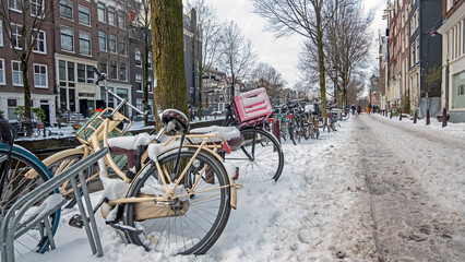 Fototapeta premium Snowy city Amsterdam in the Netherlands in winter