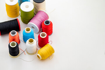 Different colored yarn on white background. Writing area