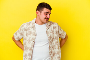 Young caucasian cool man isolated on yellow background dreaming of achieving goals and purposes