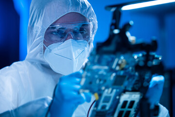 Microelectronics engineer works in a modern scientific laboratory on computing systems and...