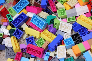 A lot colorful construction blocks from the children's model kit, close up top view texture for background