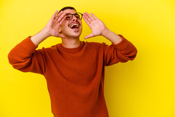 Young caucasian cool man isolated on yellow background shouting excited to front.
