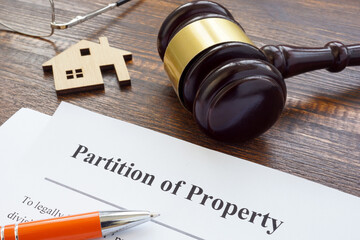 Partition of property agreement, gavel and house model.