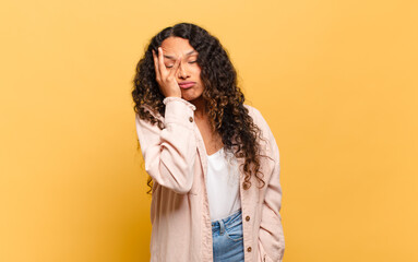 young hispanic woman feeling bored, frustrated and sleepy after a tiresome, dull and tedious task,...