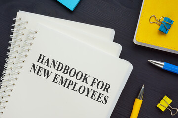 Stack of handbook for new employees on the desk. - obrazy, fototapety, plakaty