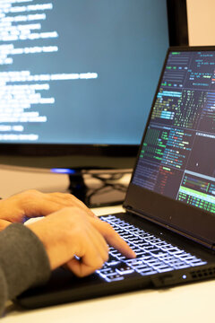 A computer programmer and hacker prints a code on a laptop keyboard to break into a mysterious organizational system.