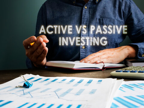 Active vs passive investing concept. The investor is sitting at the table.
