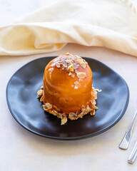 Raspberry and banana cake in a black presentation plate