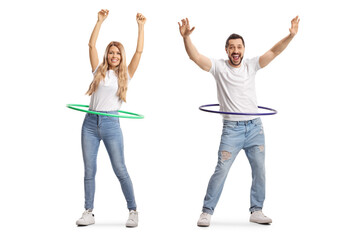 Full length portrait of a young man and woman spinning hula hoops