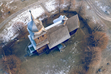 Wooden gothic church in heritage park. Open-air museum at winter time.