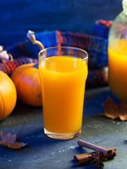 A glass of pumpkin juice, an autumnal homemade drink for Thanksgiving and Halloween.