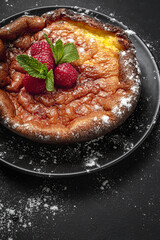 Homemade cheesecake with blueberries, currants, strawberries and mint leaves from above. Flat lay