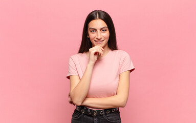 young pretty woman smiling, enjoying life, feeling happy, friendly, satisfied and carefree with...