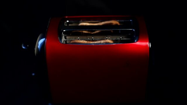 Roasted bread jump out from red toaster.4K