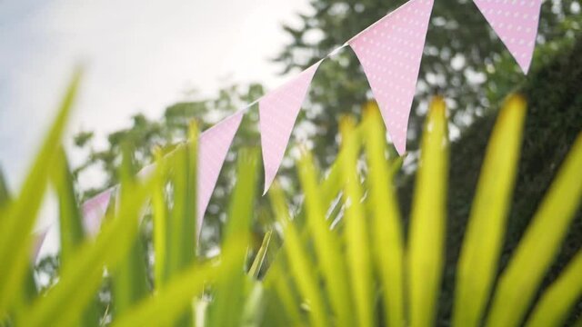 Lovely triangel pink hanging flags decoration in a gardent event celebration in summer