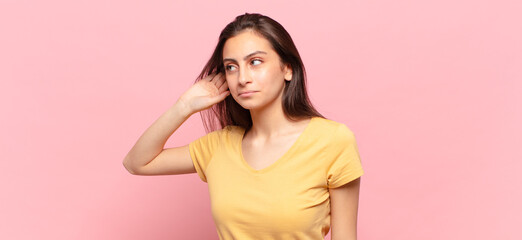 young pretty woman looking serious and curious, listening, trying to hear a secret conversation or...