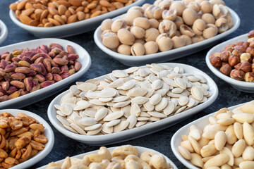 Pumpkin Seeds in selective focus. Types of nuts found in bulk on a dark background