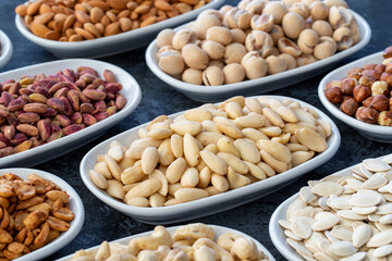 Raw almonds in selective focus. Types of nuts found in bulk on a dark background
