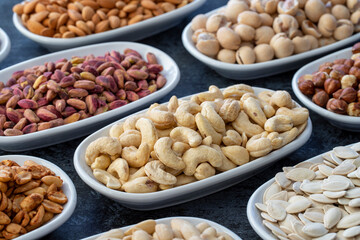 Roasted cashews in selective focus. Types of nuts found in bulk on a dark background