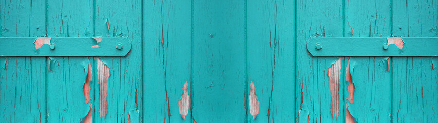 old abstract turquoise colorful painted exfoliate rustic wooden boards / wooden gate / wooden door texture - wood background banner panorama long shabby