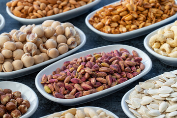 Pistachio kernels in selective focus. Types of nuts found in bulk on a dark background