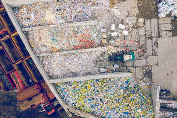 Storage of solid household waste, plastic bottles and garbage bags. Land pollution. Aerial top view.