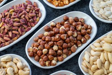 Hazelnut in selective focus. Types of nuts found in bulk on a dark background. Top view nuts