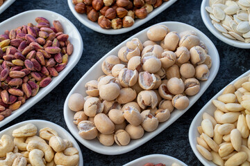 Topy fıstık or peanuts in selective focus. Types of nuts found in bulk on a dark background. Top view nuts