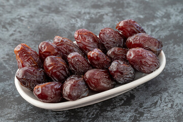 jerusalem date fruit on plate on dark background