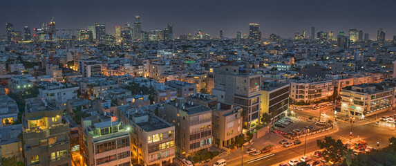 Illuminated night city, Tel aviv, Israel. Residential districts and business centre of the metropolis shot at night. Night scene of Tel-Aviv, modern buildings