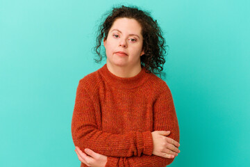 Fototapeta premium Woman with Down syndrome isolated suspicious, uncertain, examining you.