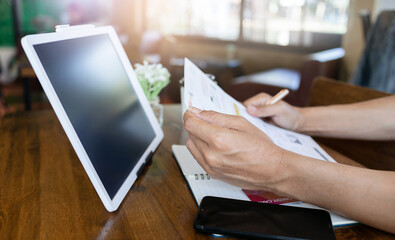 Focus on male hand reading contract on credit card statement