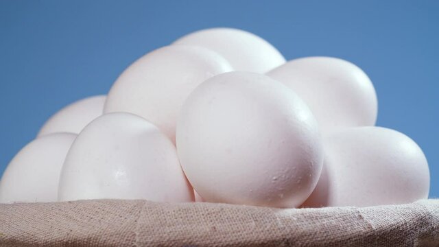 Chicken eggs in the basket, Rotating shot, Chicken white fresh raw eggs in an egg container