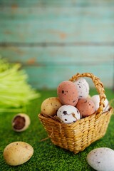 Easter freckled chocolate eggs on green grass background, selective focus