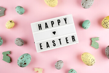 Easter spring holiday greeting card. Lightbox with text Happy Easter. colorful easter eggs, rabbits.