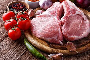fresh raw new-york steak on wooden Board on wooden background with salt and pepper in a rustic style.