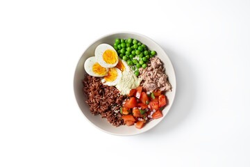 Bowl with rice, tuna, green peas and chopped tomatoes