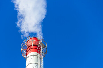 Smoke coming from the chimney of a thermal power plant in St. Petersburg. The use of natural gas in...