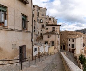 Fototapeta na wymiar view of the old city center in Cuenca with a narrow street leading down to the Casas Colgadas or 