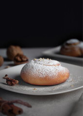 Sweet bun with nuts and powdered sugar