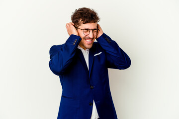 Young business caucasian man isolated on white background covering ears with hands.