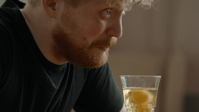 CRASH ZOOM Funny Caucasian male preparing himself a raw eggs drink after workout