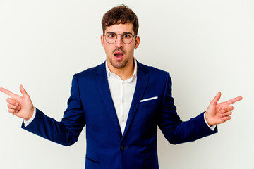 Young business caucasian man isolated on white background pointing to different copy spaces, choosing one of them, showing with finger.