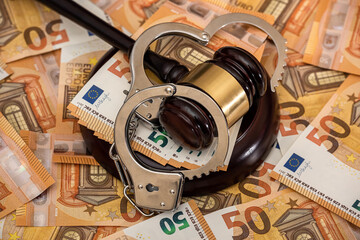 Handcuffs and euro banknotes