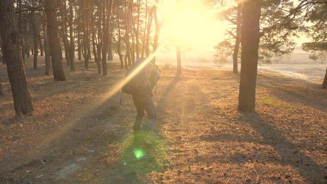 concept sciatic rheumatism back pain the medicine. man traveler tourist with a backpack pulled his back tired face pain. hiker concept travel lifestyle difficulties tourism sunlight sunset