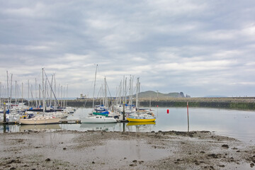  Sailboats in the harbor of Howth, Ireland on a cloudy day 