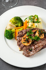 Delicious juicy grilled steak and shrimp with grilled broccoli and cauliflower.  Surf and Turf style.