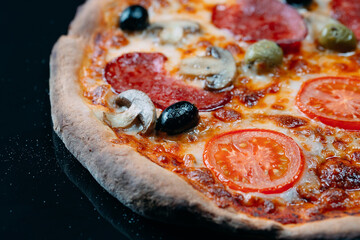 pizza Margarita close up with cheese and tomatoes.