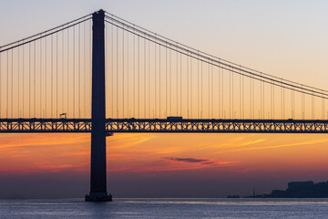 Fototapeta na wymiar 25 de Abril Bridge during sunrise